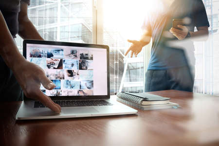 double exposure of new modern laptop computer with businessman hand working and business strategy as conceptの写真素材