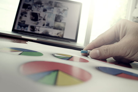 business documents on office table with smart phone and laptop computer and graph business with...