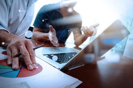 business documents on office table with smart phone and laptop computer and graph business with...