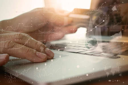 close up of hands using laptop and holding credit card with social media diagram as Online shopping conceptの写真素材