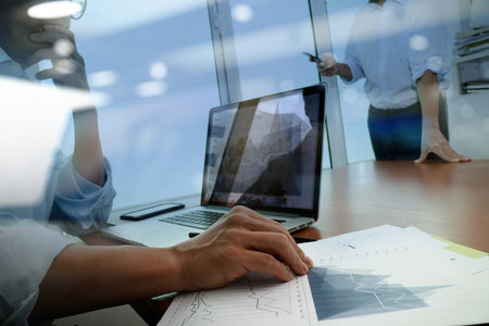 business documents on office table with smart phone and digital tablet and graph business diagram...
