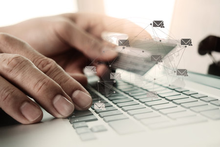close up of hands using laptop and holding credit card with social media diagram as Online shopping...