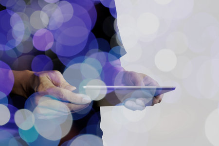 Double exposure of businessman hand using Tablet computer with colour cloud concept
