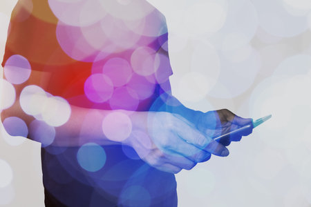 Double exposure of businessman hand using Tablet computer with colour cloud concept