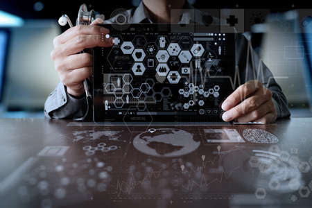 Medicine doctor hand working with modern computer interface and digital layer effect as medical network conceptの写真素材