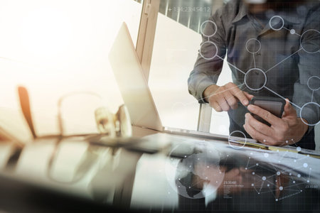 businessman hand working with new modern computer and smart phone and digital business strategy on...