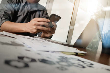 Medicine doctor hand working with modern computer and smart phone with blank screen on wooden desk as medical conceptの写真素材