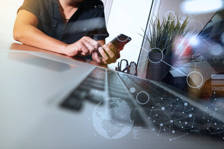 businessman hand working with new modern computer and smart phone and business strategy diagram on...