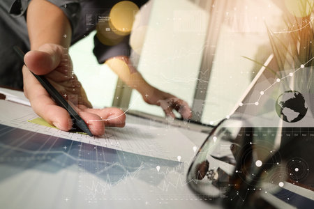 businessman hand working with new modern computer and business strategy documents and difital layers...