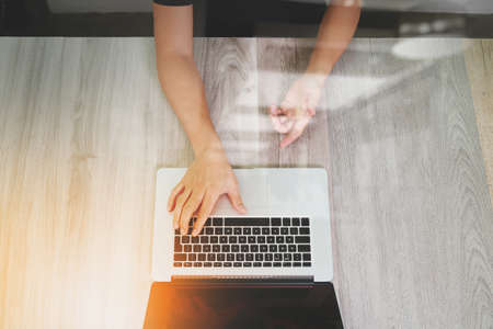 top view of Designer hand working with laptop computer on wooden desk as responsive web design conceptの写真素材