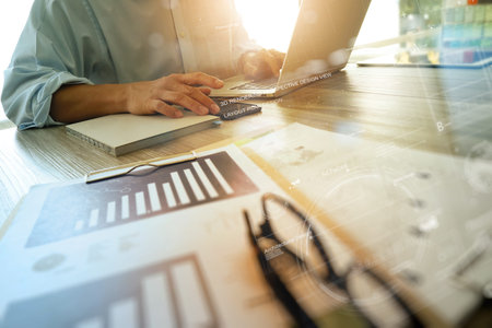 business documents on office table with smart phone and digital tablet and digital graph business...