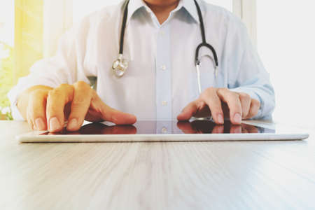 Medicine doctor hand working with modern digital tablet pad as medical network conceptの写真素材
