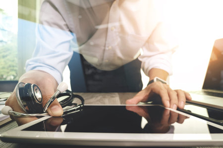 Medicine doctor hand working with modern digital tablet computer interface as medical network conceptの写真素材