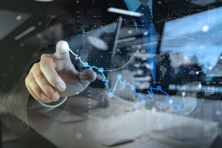 double exposure of businessman hand working with new modern computer and business strategy as...