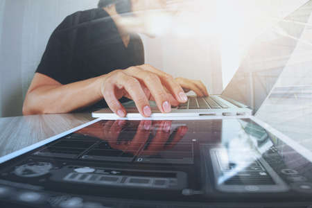 Website designer working digital tablet and computer laptop with smart phone and digital design diagram on wooden desk as conceptの写真素材