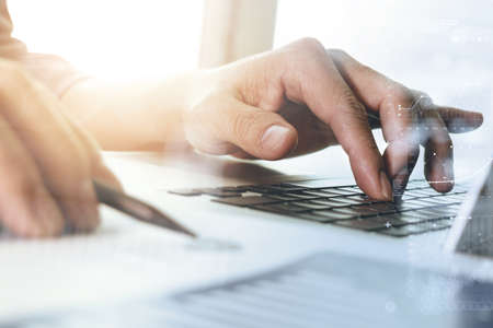 close up of businessman hand working with new modern computer and digital business strategy diagram as conceptの写真素材