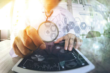 Medicine doctor hand working with modern digital tablet computer with  stethoscope as medical network conceptの写真素材