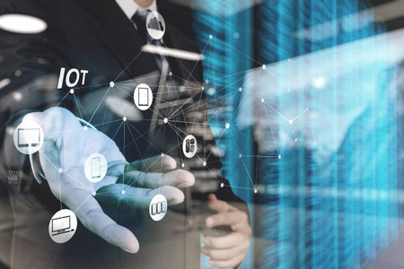 double exposure of hand showing Internet of things (IoT) word diagram as conceptの写真素材