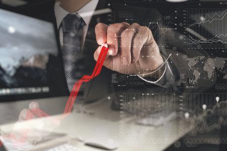 double exposure of businessman hand working with new modern computer and business strategy as...