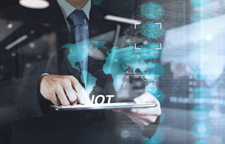 double exposure of hand showing Internet of things (IoT) word diagram as conceptの写真素材