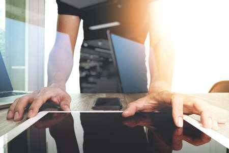 Website designer working digital tablet and computer laptop and digital design diagram on wooden desk as conceptの写真素材