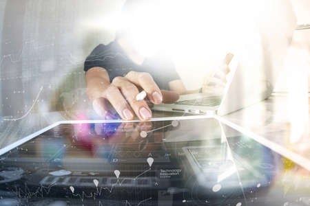 Website designer working digital tablet and computer laptop with smart phone and digital design diagram on wooden desk as conceptの写真素材