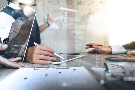Businessman making presentation with his colleagues and business strategy digital layer effect at the office as conceptの写真素材