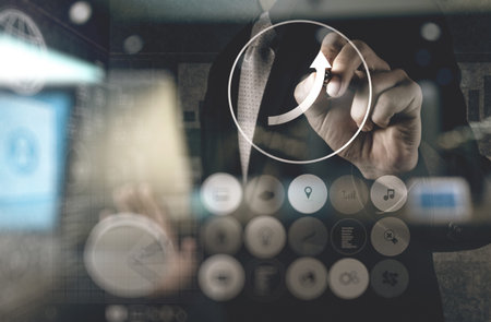 double exposure of businessman hand working with new modern computer and business strategy as...