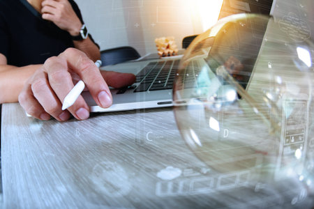 light bulb with designer hand working with laptop computer and creative business strategy as conceptの写真素材