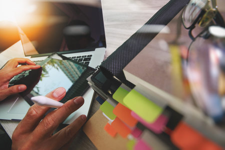 Website designer working digital tablet and computer laptop with smart phone and digital design...