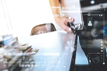 Medicine doctor hand holding modern digital tablet computer and laptop computer as medical network conceptの写真素材