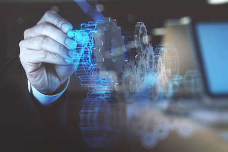 double exposure photo of engineer businessman hand draws gear to success as conceptの写真素材