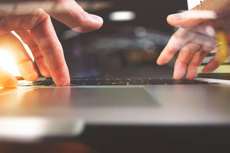 close up of Designer hand working with laptop computer on wooden desk as responsive web design conceptの写真素材