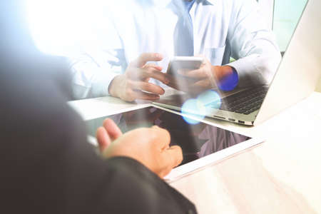 Business team meeting present. Photo professional investor working with new startup project. Finance managers meeting.Digital tablet laptop computer design smart phone using.Sun flare effectの写真素材