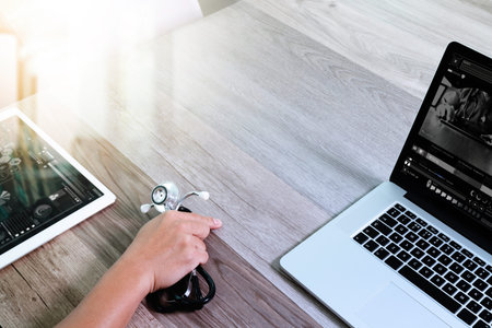 Medical technology concept. Doctor hand working with stethoscope and laptop computer with medical...