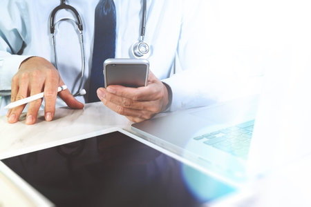 Medical technology concept. Doctor hand working with modern digital tablet and laptop computer with...