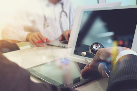 Medical technology network team concept. Doctor hand working with smart phone modern digital tablet...