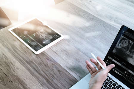 businessman hand working with stylus pen digital tablet smart phone and laptop computer. attending video conference in modern office. On wood desk. View from top. Double exposure effects, Minimalismの写真素材