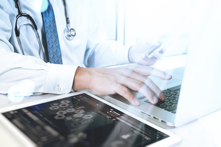 Medical technology concept. Doctor hand working with modern digital tablet and laptop computer with...