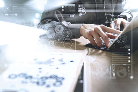 Medical technology concept. Doctor hand working with modern digital tablet dock screen computer with medical chart interface, Sun flare effect photoの写真素材