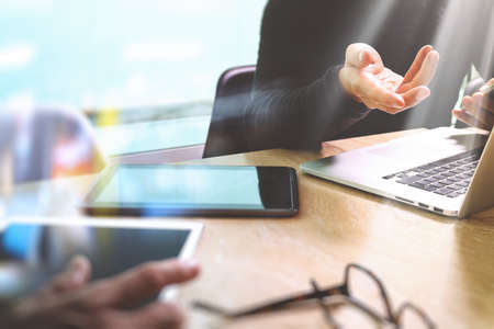 Business team meeting present. Photo professional investor working with new startup project. Finance managers meeting.Digital tablet laptop computer design smart phone using, Sun flare effectの写真素材