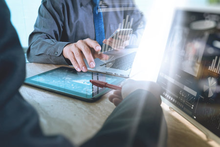Business team meeting present. Photo professional investor working with new startup project. Finance managers meeting.Digital tablet laptop computer design smart phone using, Sun flare effectの写真素材