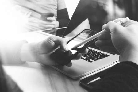 Business team meeting present. Photo professional investor working with new startup project. Finance managers meeting.Digital tablet laptop computer design smart phone using, black whiteの写真素材
