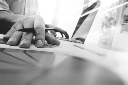 business man hand working on laptop computer with digital layer business graph information diagram...