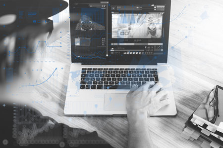 website designer hand attending video conference with laptop computer at desk in office. virtual...