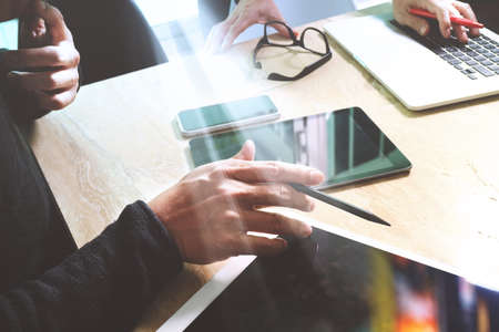 Business team meeting present. Photo professional investor working with new startup project. Finance managers meeting.Digital tablet laptop computer design smart phone using, Sun flare effectの写真素材