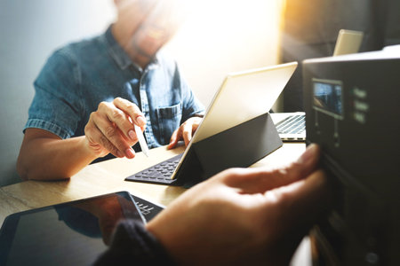 Website designer working digital tablet and computer laptop with digital tablet and digital design...
