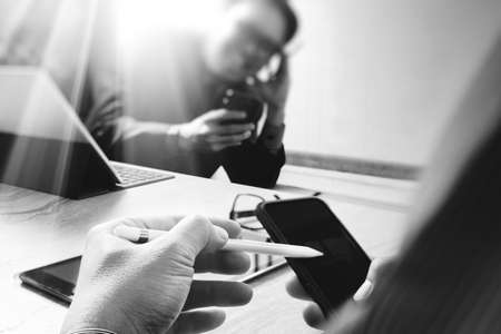 Business team meeting present. professional investor working new startup project. Finance managers meeting.Digital tablet keyboard docking screen computer design smart phone using, black whiteの写真素材