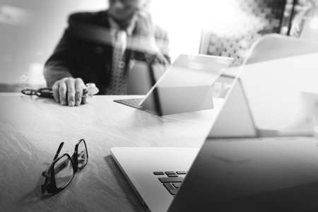 Business team meeting present. professional investor working new startup project. Finance managers meeting.Digital tablet keyboard docking screen computer design smart phone using, black whiteの写真素材