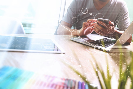 Photo website graphic designer hand meeting team with new project modern studio.Modern laptop digital tablet smart phone on marble table.pan-tone colors documents, sun flare effectの写真素材